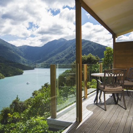The private furnished balcony of a Frond Suite at Punga Cove has sweeping views across Endeavour Inlet in the Marlborough Sounds, New Zealand