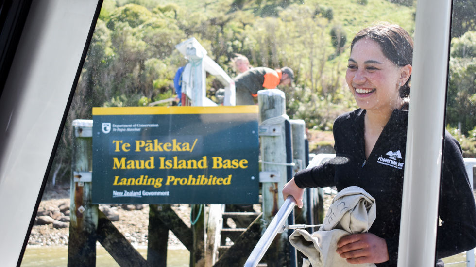 Female staff member delivering mail to Te Pākeka/Maud Island on the Pelorus Mail Boat.