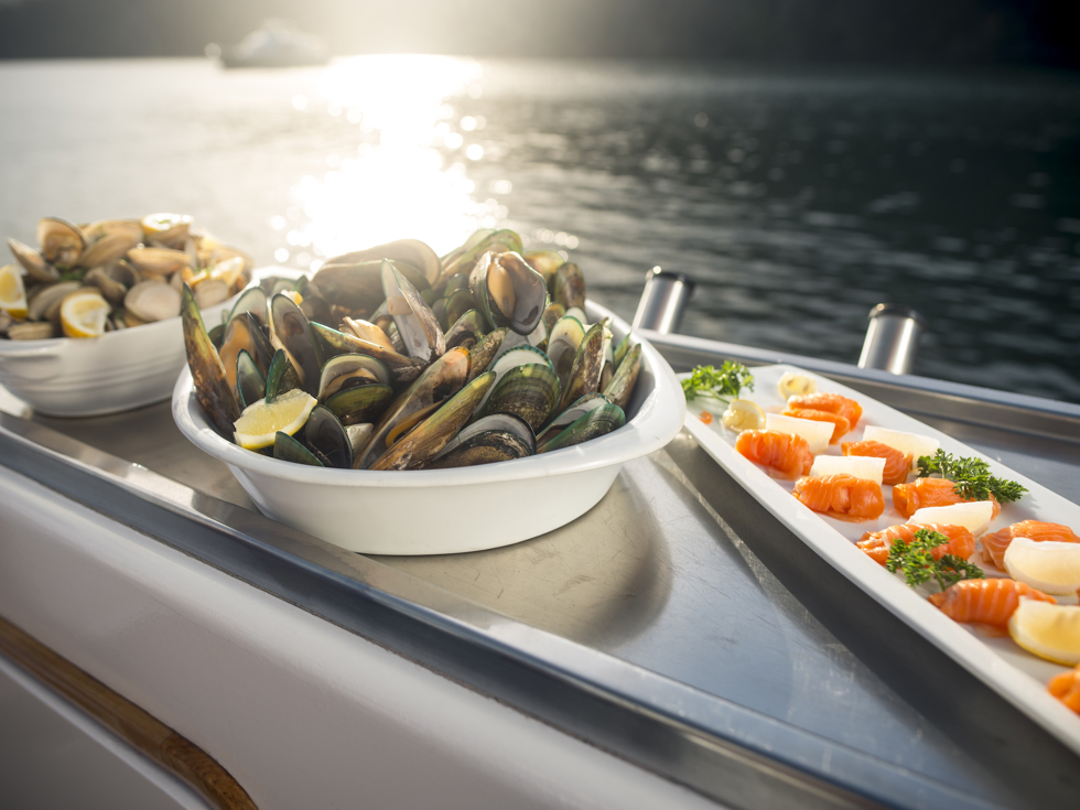 Cloudy Bay Clams, Greenshell mussels and Regal salmon are served at the source on a Seafood Odyssea cruise in New Zealand's spectacular Marlborough Sounds from Picton.