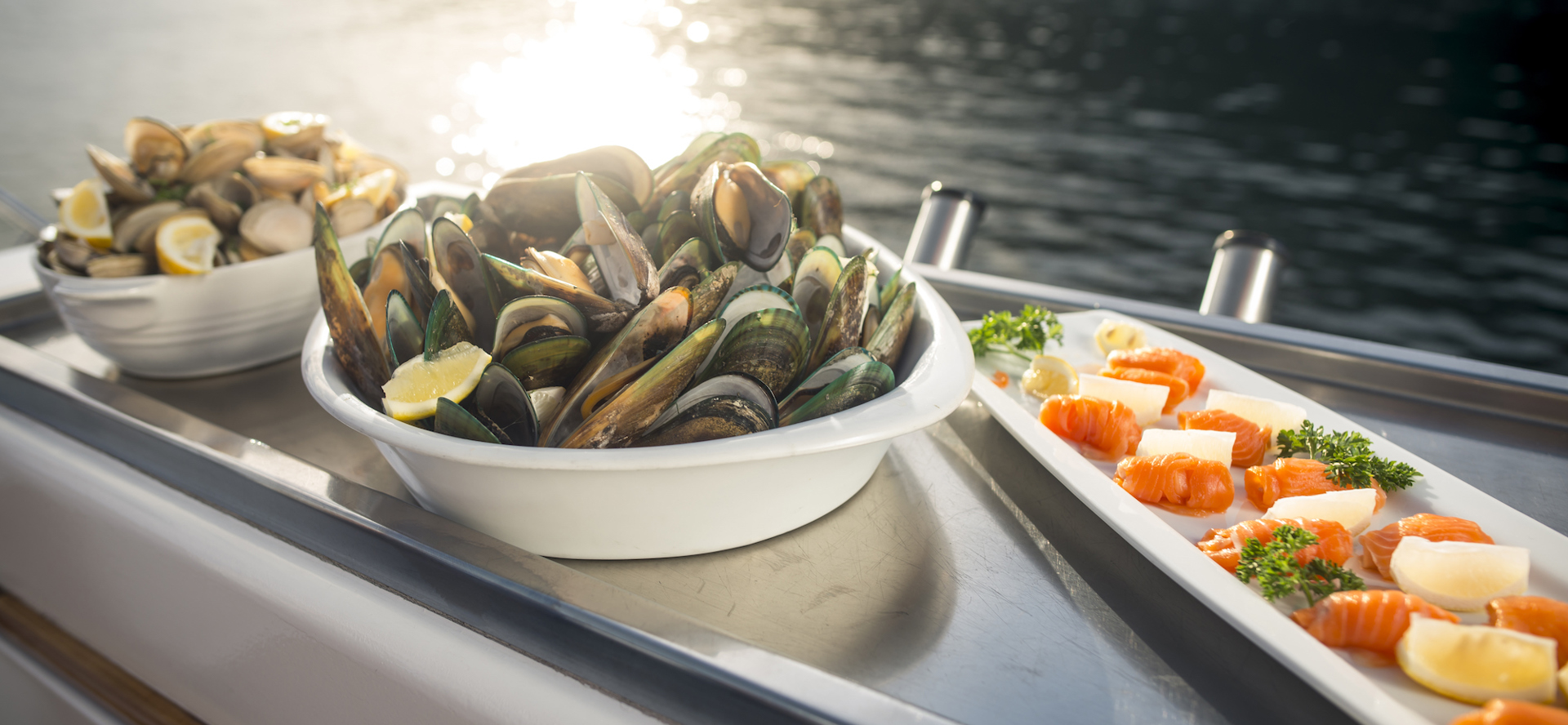 Cloudy Bay Clams, Greenshell mussels and Regal salmon are served at the source on a Seafood Odyssea cruise in New Zealand's spectacular Marlborough Sounds from Picton.